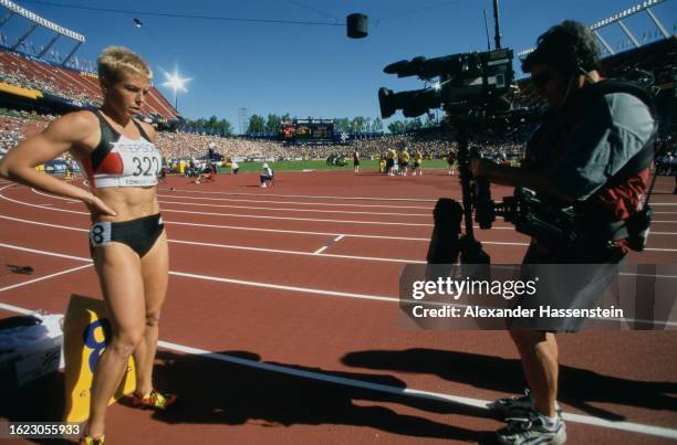 German athlete Grit Breuer filmed by a camera operator ahead of the women's 400 metres event of the 2001 IAAF World Championships, held at...