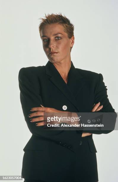 German athlete Grit Breuer wearing a black suit with her arms folded during a studio portrait session, against a white background, July 1997....