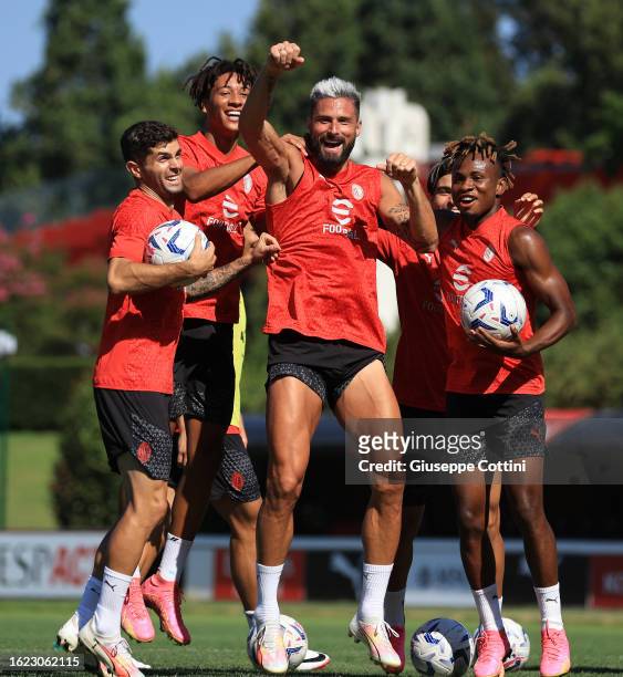 Olivier Giroud of AC Milan celebrates with his team-mates during an AC Milan training session at Milanello on August 18, 2023 in Cairate, Italy.