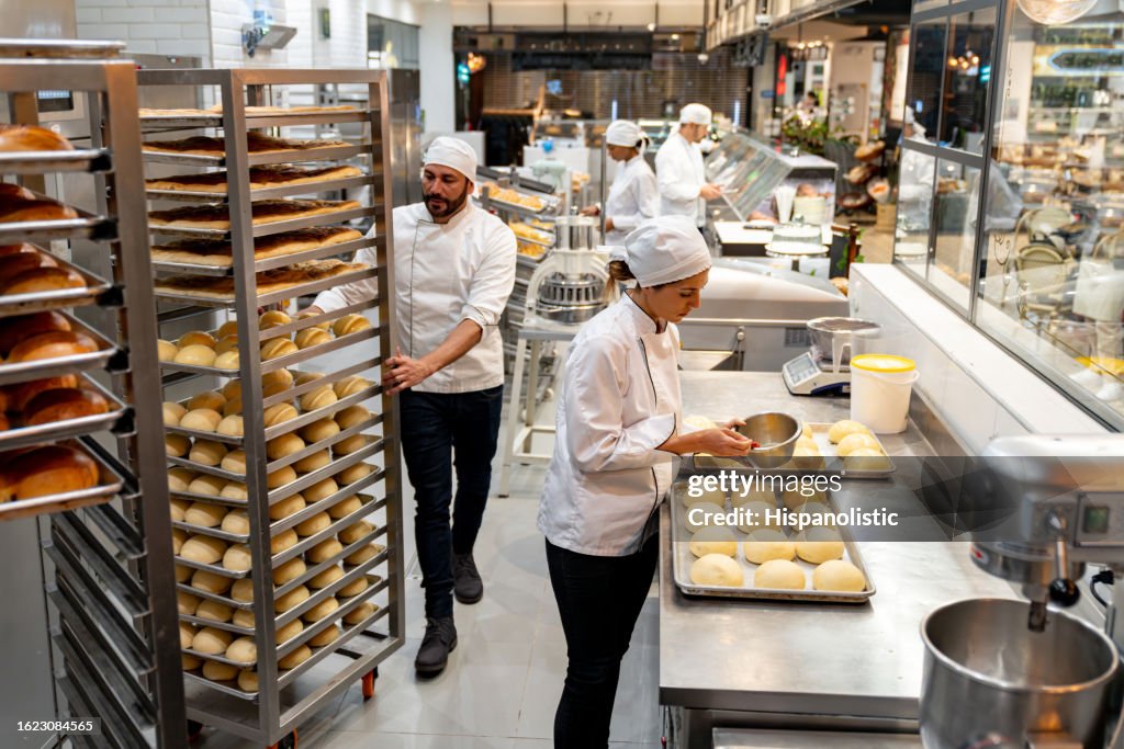 Group of employees working at a bakery baking bread