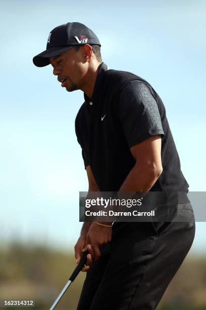 Tiger Woods reacts after he missed a putt on the fourth hole green during the first round of the World Golf Championships - Accenture Match Play at...