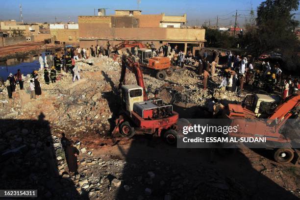 Iraqi men gather at the scene of the rubble of a house destroyed in an US military airstrike in the southern Iraqi city of Basra on April 03, 2008. A...