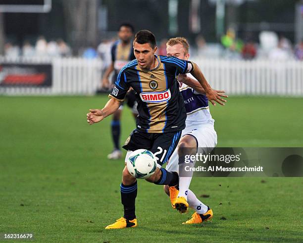 Midfielder Michael Farfan of the Philadelphia Union runs away from forward Jamie Watson of Orlando City February 9, 2013 in the first round of the...
