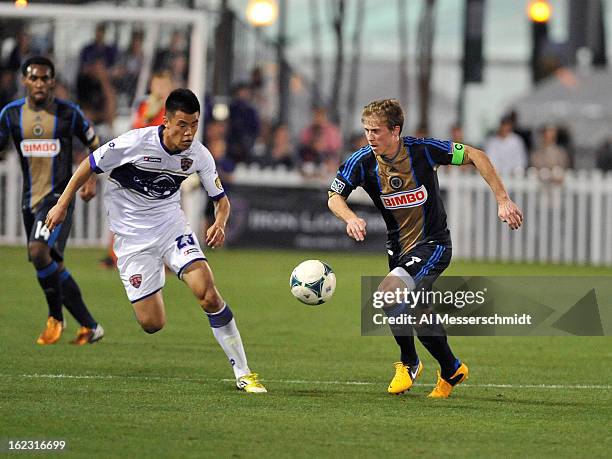 Forward Long Tan of Orlando City runs upfield against midfielder Brian Carroll of the Philadelphia Union February 9, 2013 in the first round of the...