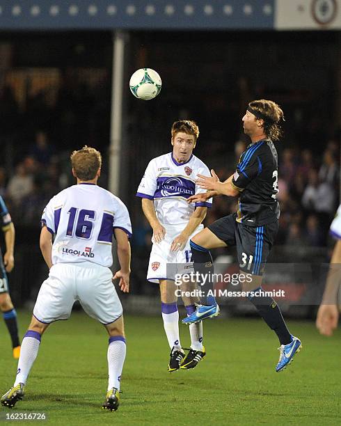 Midfielder James O'Connor of Orlando City battles defender Jeff Parke the Philadelphia Union February 9, 2013 in the first round of the Disney Pro...