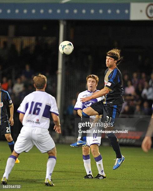 Midfielder James O'Connor of Orlando City battles defender Jeff Parke the Philadelphia Union February 9, 2013 in the first round of the Disney Pro...