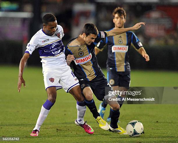 Forward Dennis Chin of Orlando City battles for a ball against Eric Schoenie of the Philadelphia Union February 9, 2013 in the first round of the...