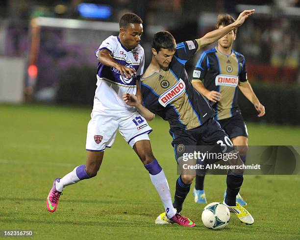 Forward Dennis Chin of Orlando City battles for a ball against defender Eric Schoenie of the Philadelphia Union February 9, 2013 in the first round...
