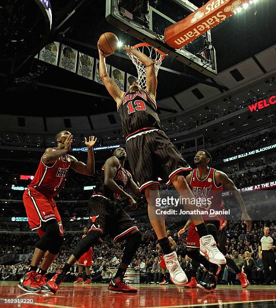 Joakim Noah of the Chicago Bulls shoots over teammate Loul Deng and Chris Bosh and Udonis Haslem of the Miami Heat at the United Center on February...
