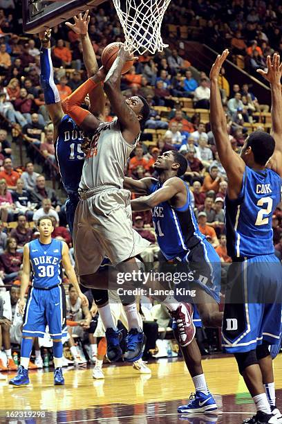 Barksdale of the Virginia Tech Hokies goes to the hoop against Josh Hairston and Amile Jefferson of the Duke Blue Devils at Cassell Coliseum on...