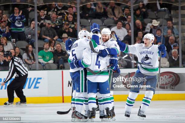 Keith Ballard, Jason Garrison, Zack Kassian and Ryan Kesler of the Vancouver Canucks celebrate a win against the Dallas Stars at the American...