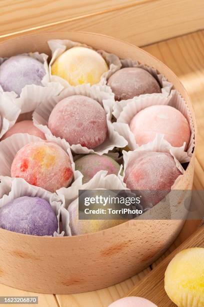 set of colorful daifuku mochi dessert on wooden background - adzuki bean stock pictures, royalty-free photos & images