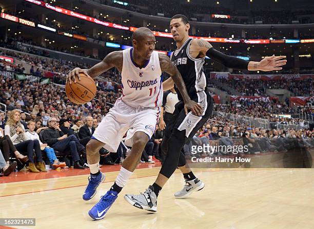Jamal Crawford of the Los Angeles Clippers looks to dribble around Danny Green of the San Antonio Spurs at Staples Center on February 21, 2013 in Los...