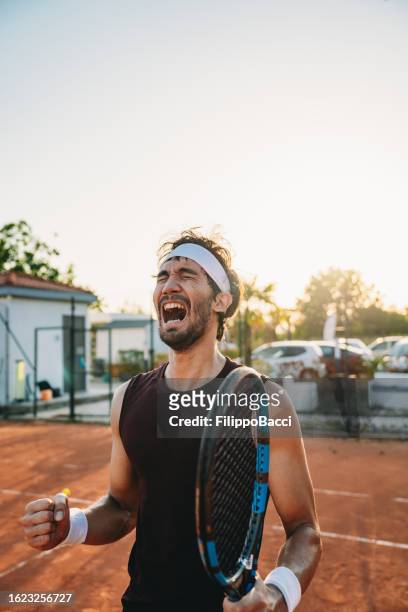 a tennis player is celebrating his victory - finals game one stock pictures, royalty-free photos & images