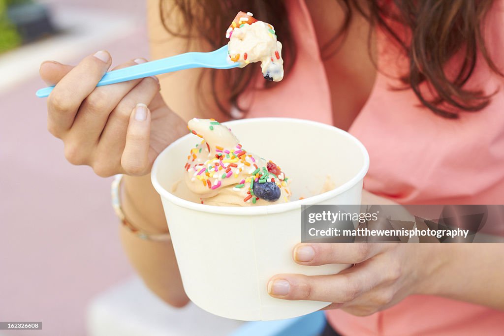 Woman Eating Frozen Yogurt With Berries