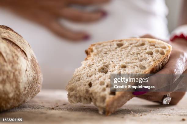 a young celiac woman suffers from abdominal pain after eating fresh bread. - stiga stock pictures, royalty-free photos & images