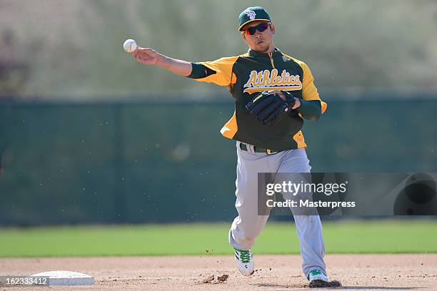 Hiroyuki Nakajima of Oakland Athletics fields during Oakland Athletics Spring Training at Papago Park on February 21, 2013 in Phoenix, Arizona.