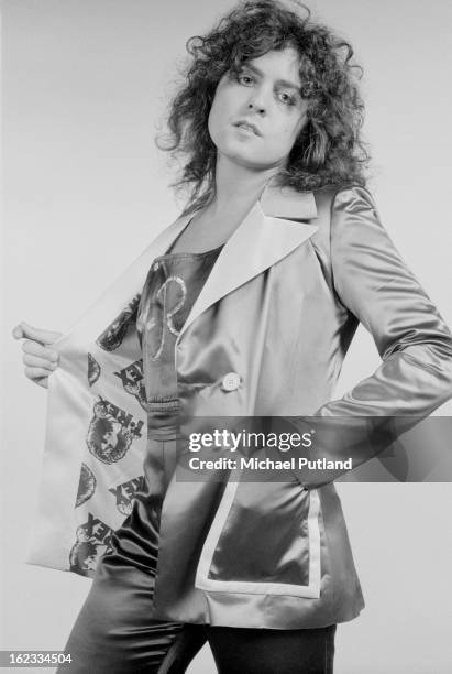 British singer, songwriter and musician Marc Bolan , modelling a satin jacket with a T-Rex print lining, London, 1973.