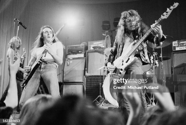 English rock group Status Quo performing on stage, 1973. Left to right: Rick Parfitt, Francis Rossi and Alan Lancaster.