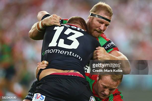 Trent Merrin of the Dragons is tackled by Michael Croker of the Rabbitohs during the NRL Charity Shield match between the South Sydney Rabbitohs and...