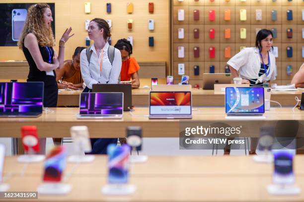 People visit the Apple store in New York City on August 18, 2023. Apple will pay up to $500 million to users of many pre-2018 model iPhones, for an...