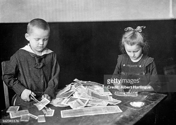 Devaluation of the Mark. Children playing with banknotes which have no more value, because of the inflation. Weimar Republic , circa 1919.