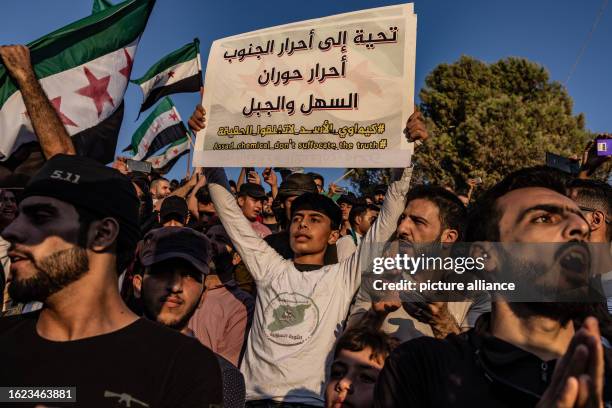 August 2023, Syria, Idlib: Syrians take part in a demonstration against the Syrian President Bashar al-Assad's regime and in support of...