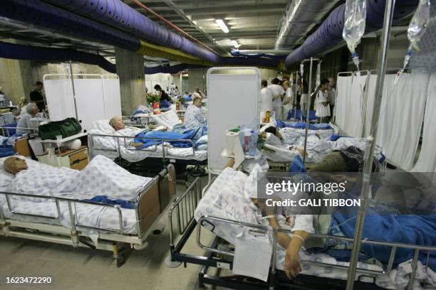 Patients from the cardiology and oncology departments lie side by-side-by in their beds after being transferred to the shelter of the Rambam hospital...