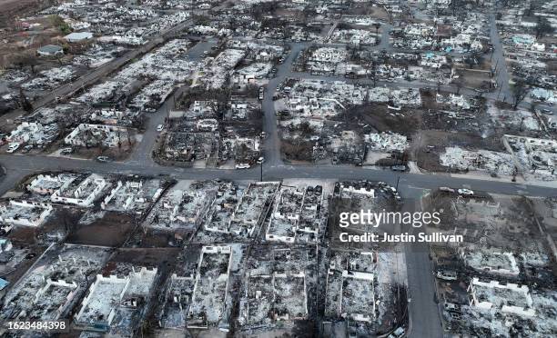 In an aerial view, burned cars and homes are seen in a neighborhood that was destroyed by a wildfire on August 18, 2023 in Lahaina, Hawaii. At least...