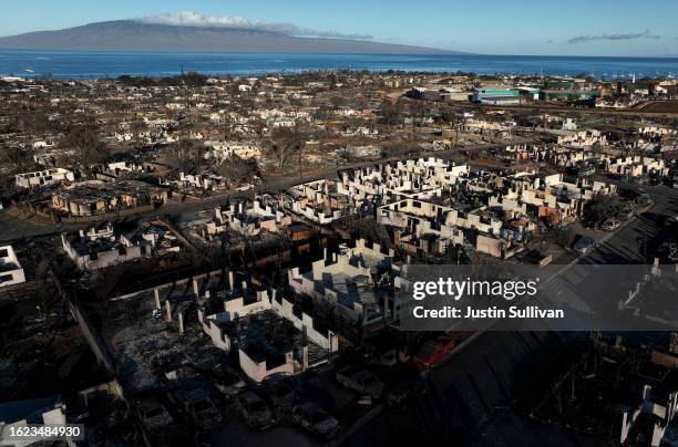 In an aerial view, burned cars and homes are seen in a neighborhood that was destroyed by a wildfire on August 18, 2023 in Lahaina, Hawaii. At least...