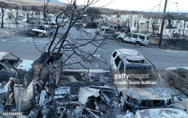 In an aerial view, burned cars and homes are seen in a neighborhood that was destroyed by a wildfire on August 18, 2023 in Lahaina, Hawaii. At least...
