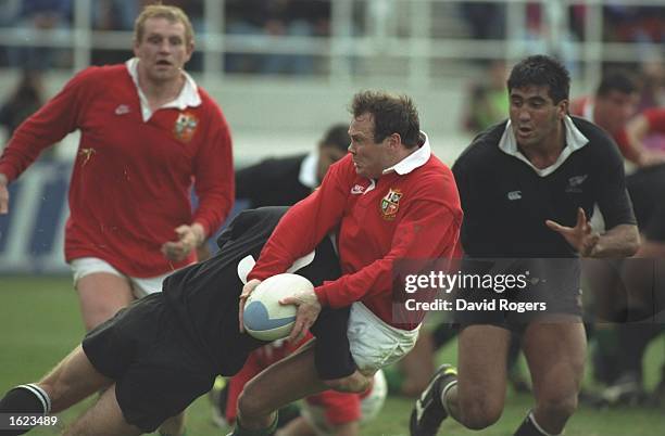 Ieaun Evans of the British Lions is tackled during the third test against New Zealand in Auckland, New Zealand. New Zealand won the match 30-13 and...