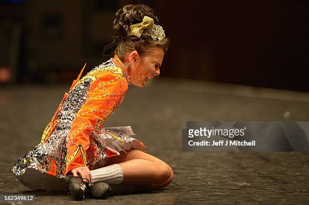 Dancer grimaces after falling during the 29th All Scotland Irish Dance Championship on February 22, 2013 in Glasgow, Scotland. As many 2,000...