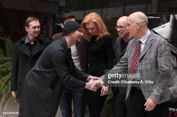 Writer Nicolai Lilin greets actor John Malkovich and director Gabriele Salvatores during the 'Educazione Siberiana' photocall at Visconti Palace...