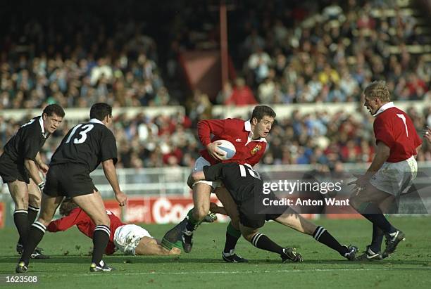 Gavin Hastings of the British Lions is tackled by Grant Fox of the New Zealand All Blacks during the first test in Christchurch, New Zealand. New...