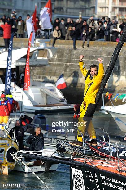 Italian skipper Alessandro di Benedetto celebrates on his monohull "Team plastique" after crossing the finish line of the 7th Vendee Globe...