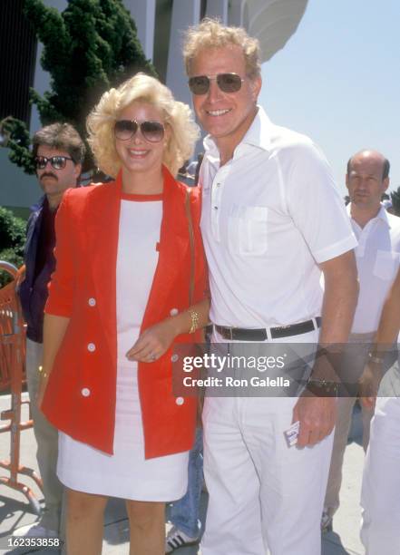 Actor Wayne Rogers and date Amy Hirsh attend the NBA Playoffs Game 7: Los Angeles Lakers vs. Utah Jazz on May 22, 1988 at The Forum in Los Angeles,...