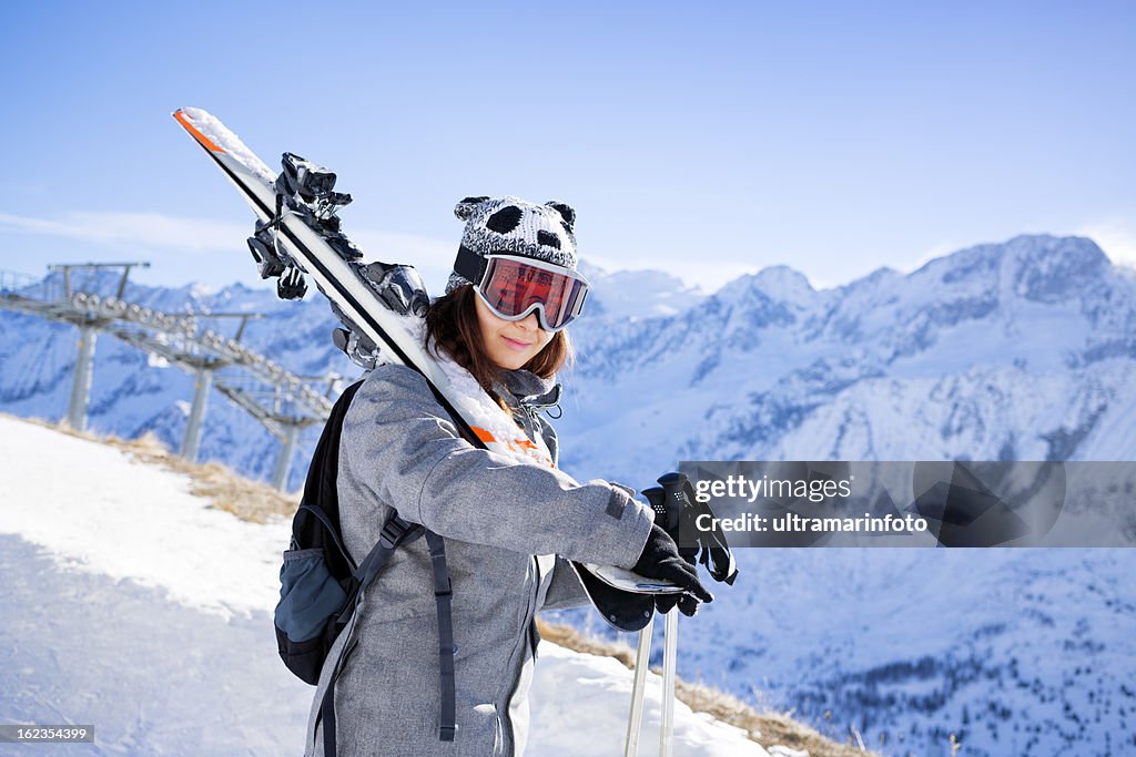 Girl skier on the top of a snowy  mountain slope