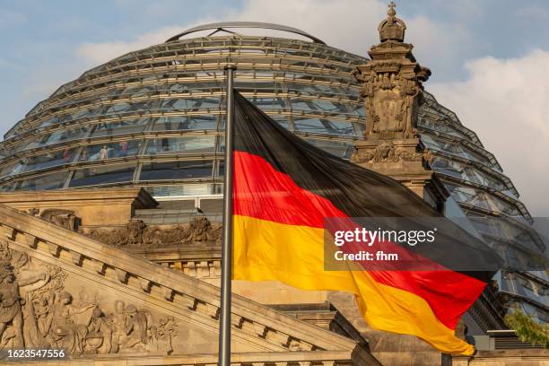 deutscher bundestag - dome of the reichstag building with german flag (german parliament building) - berlin, germany - german flag wallpaper stock pictures, royalty-free photos & images