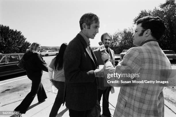 American military analyst and political activist Daniel Ellsberg is interviewed by a journalist from radio station FM98 outside a building on the...