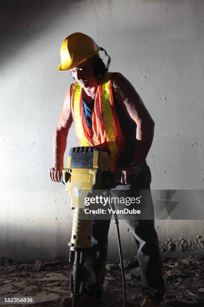 male worker using jackhammer in tunnel - jackhammer stock pictures, royalty-free photos & images