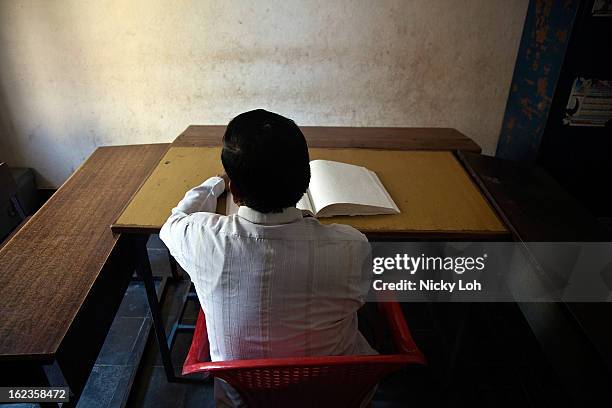 Blind teacher reads Braille with his hands at the Government High School for The Blind on February 22, 2013 in Kadapa, India. The school which is...