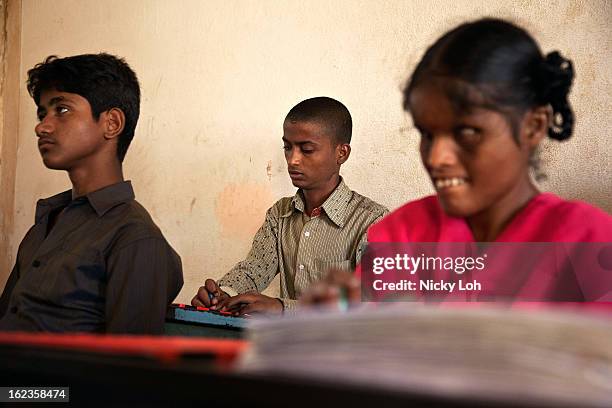 Visually impaired students write in Braille with slates at the Government High School for The Blind on February 22, 2013 in Kadapa, India. The school...