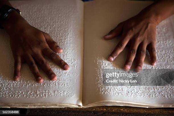 Student reads Braille with her hands at the Government High School for The Blind on February 22, 2013 in Kadapa, India. The school which is funded by...