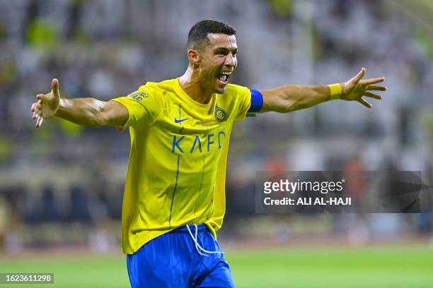 Nassr's Portuguese forward Cristiano Ronaldo celebrates after scoring during the Saudi Pro League football match between Al-Nassr and Al-Fateh at the...