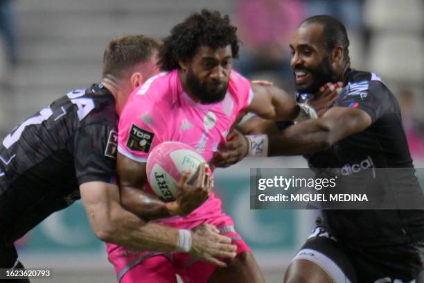 Stade Francais' Fijian fullback Peniasi Dakuwaqa is tackled by Oyonnax' Irish centre Chris Farrell and Oyonnax' French wing Daniel Ikpefan during the...