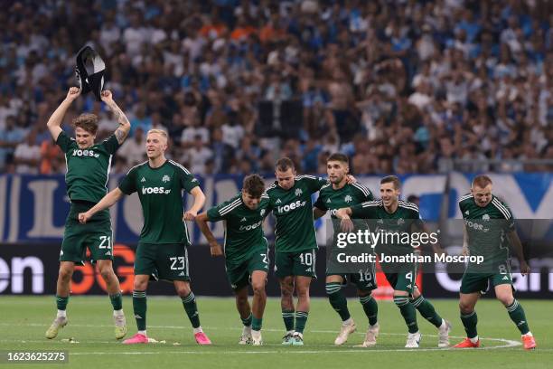 Panathinaikos FC players celebrate as team mate Filip Mladenovic scores the decisive penalty in the shoot out following the UEFA Champions League...