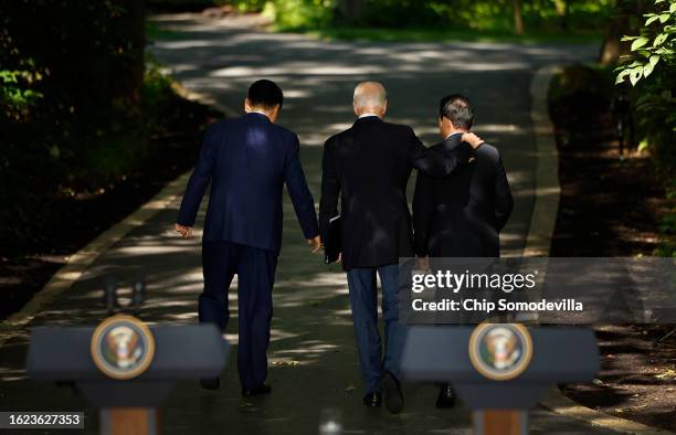 South Korean President Yoon Suk Yeol, U.S. President Joe Biden and Japanese Prime Minister Kishida Fumio walk together after holding a joint news...