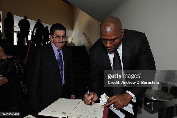 Earvin Magic Johnson signs the guest book before the memorial service for Los Angeles Lakers Owner Dr. Jerry Buss at Nokia Theatre LA LIVE on...