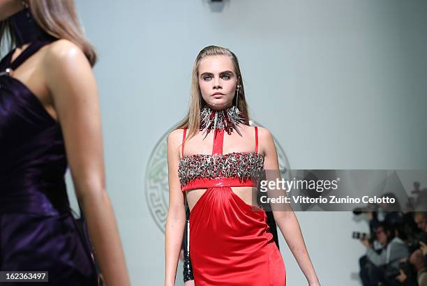 Cara Delevingne walks the runway at the Versace fashion show during Milan Fashion Week Womenswear Fall/Winter 2013/14 on February 22, 2013 in Milan,...